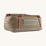 Patagonia 55 litres duffel bag in a seabird grey colour on a cream background.