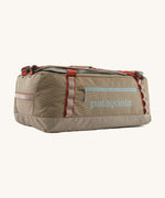 Patagonia 55 litres duffel bag in a seabird grey colour on a cream background.
