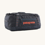Patagonia 55 litres duffel bag in a navy blue colour on a cream background.