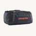 Patagonia 55 litres duffel bag in a navy blue colour on a cream background.