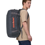 Patagonia 55 litres duffel bag in a navy blue colour being carried by an adult