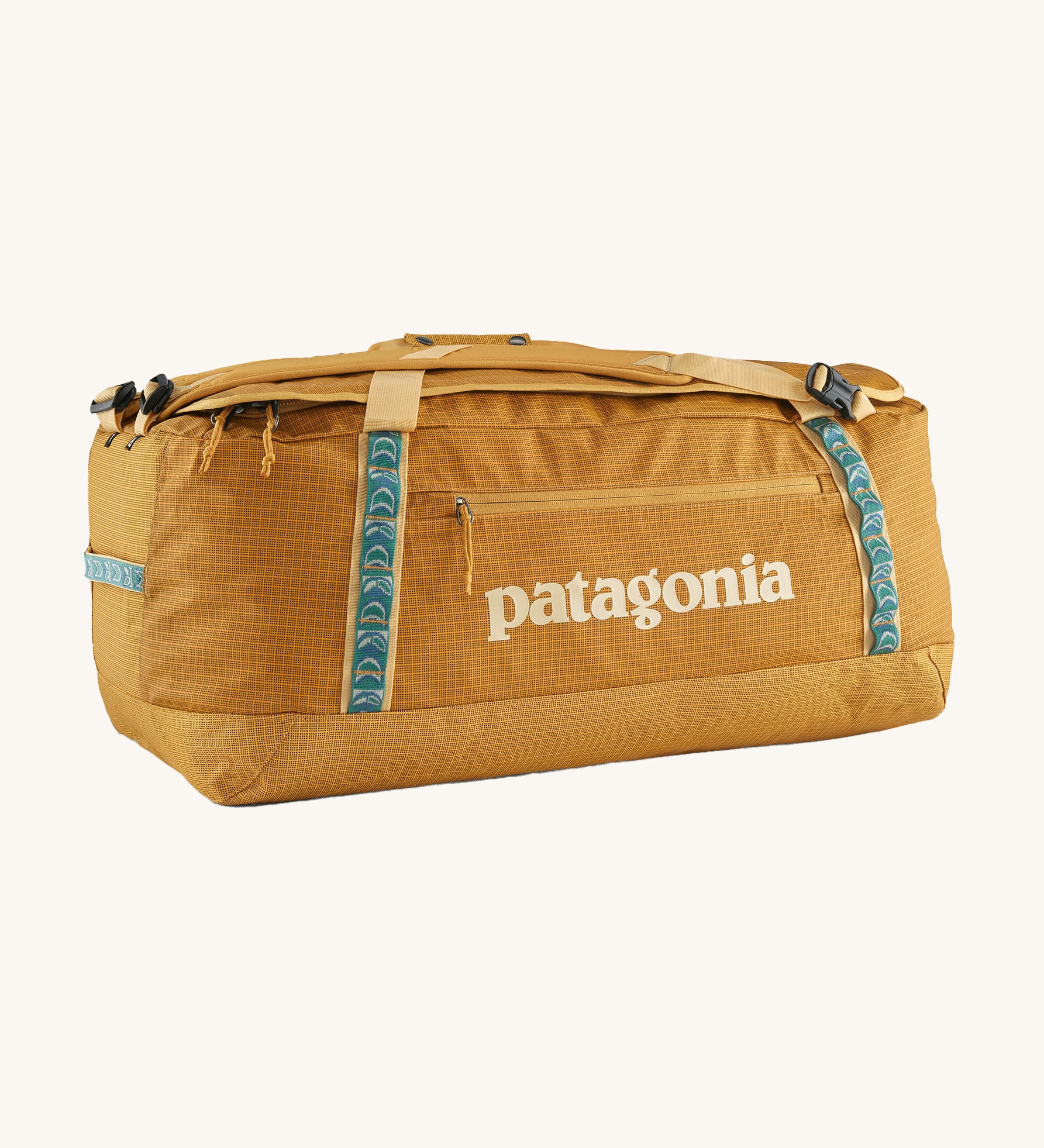 Patagonia 70 litres duffel bag in a gold colour on a cream background.