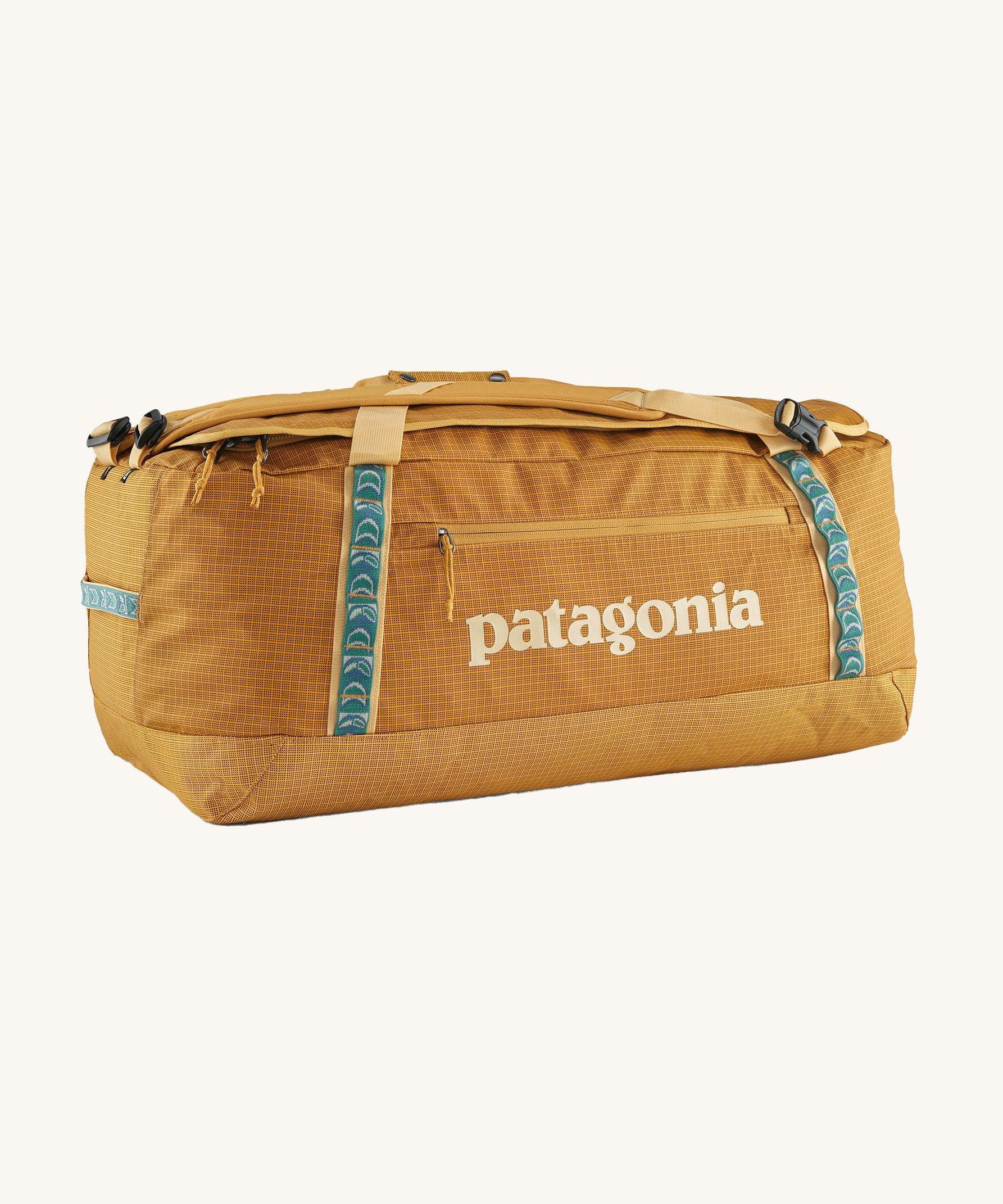 Patagonia 70 litres duffel bag in a gold colour on a cream background.