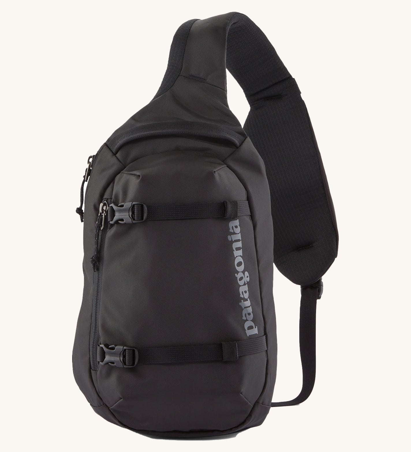 Patagonia 8L atom sling bag in a black colour on a cream background.
