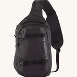 Patagonia 8L atom sling bag in a black colour on a cream background.