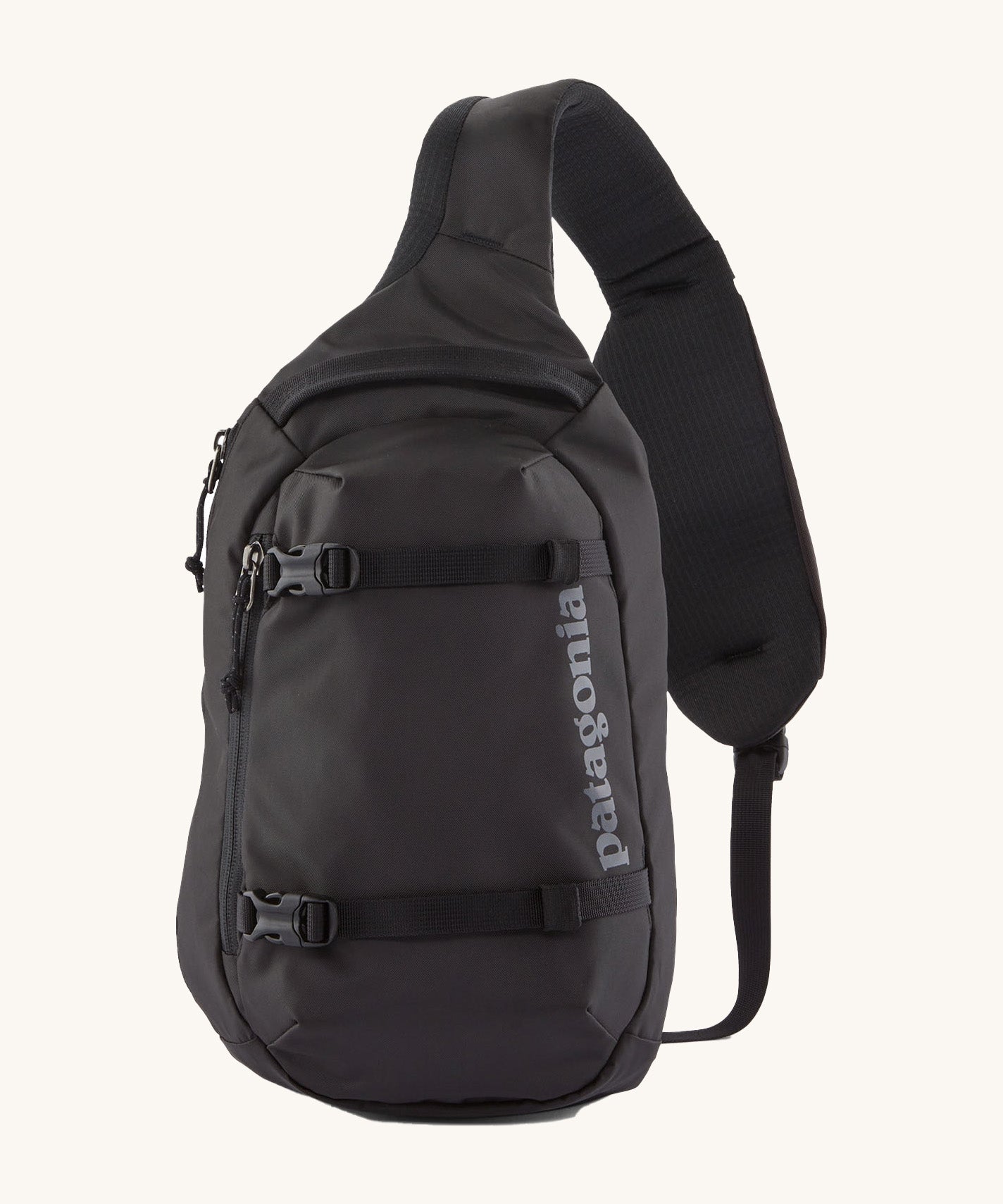 Patagonia 8L atom sling bag in a black colour on a cream background.
