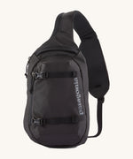 Patagonia 8L atom sling bag in a black colour on a cream background.