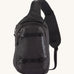 Patagonia 8L atom sling bag in a black colour on a cream background.