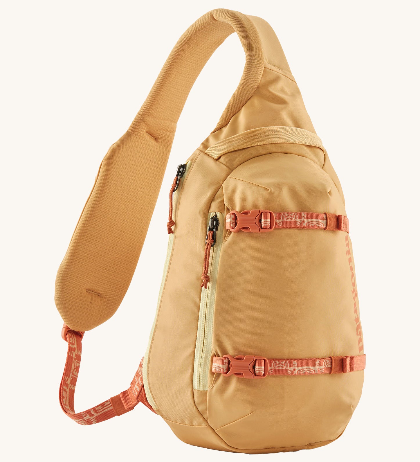 Patagonia 8L atom sling bag in a yellow colour on a cream background.