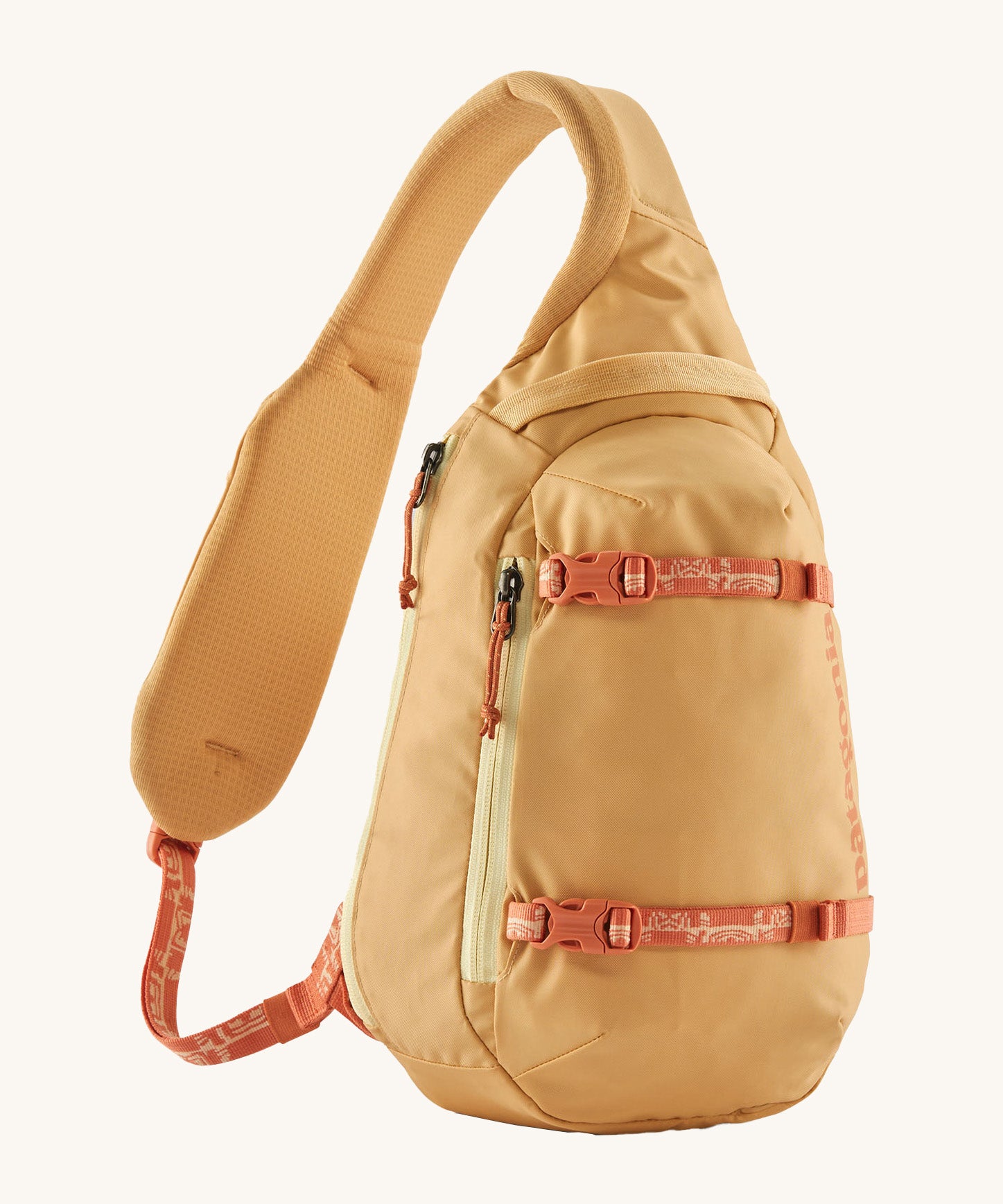 Patagonia 8L atom sling bag in a yellow colour on a cream background.