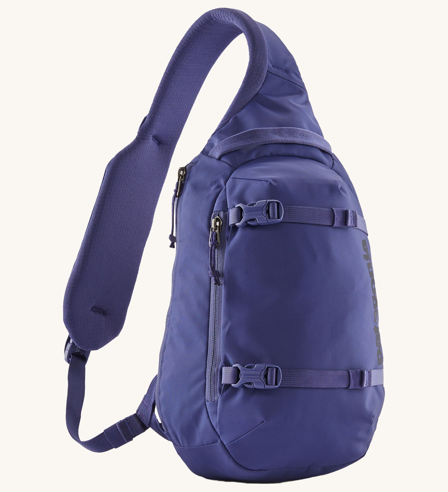 Patagonia 8L atom sling bag in a purple colour on a cream background.