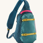 Patagonia 8L atom sling bag in a turquoise colour on a cream background.