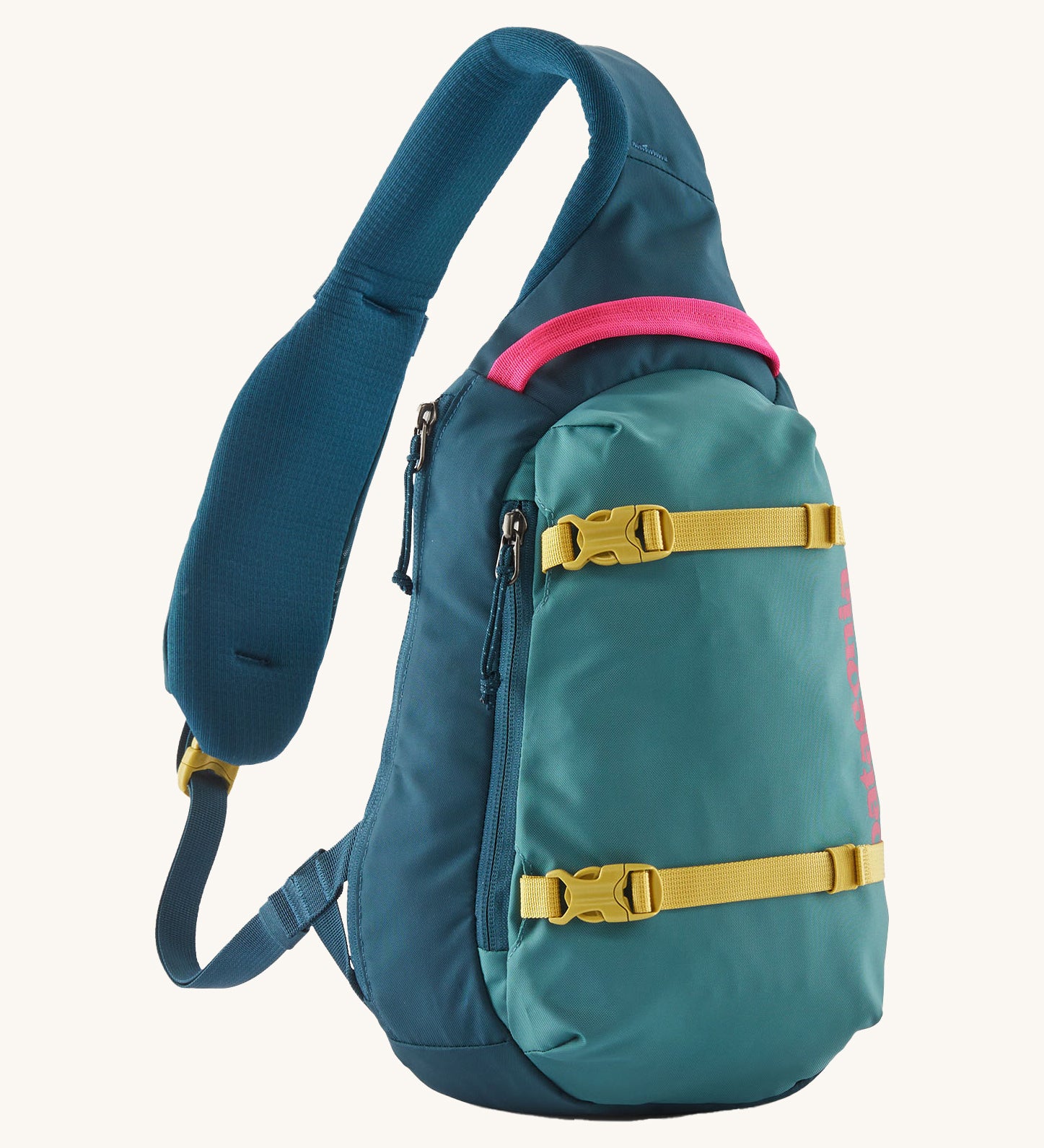 Patagonia 8L atom sling bag in a turquoise colour on a cream background.