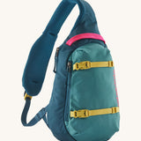 Patagonia 8L atom sling bag in a turquoise colour on a cream background.