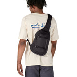 Patagonia 8L atom sling bag in a black colour worn by an adult