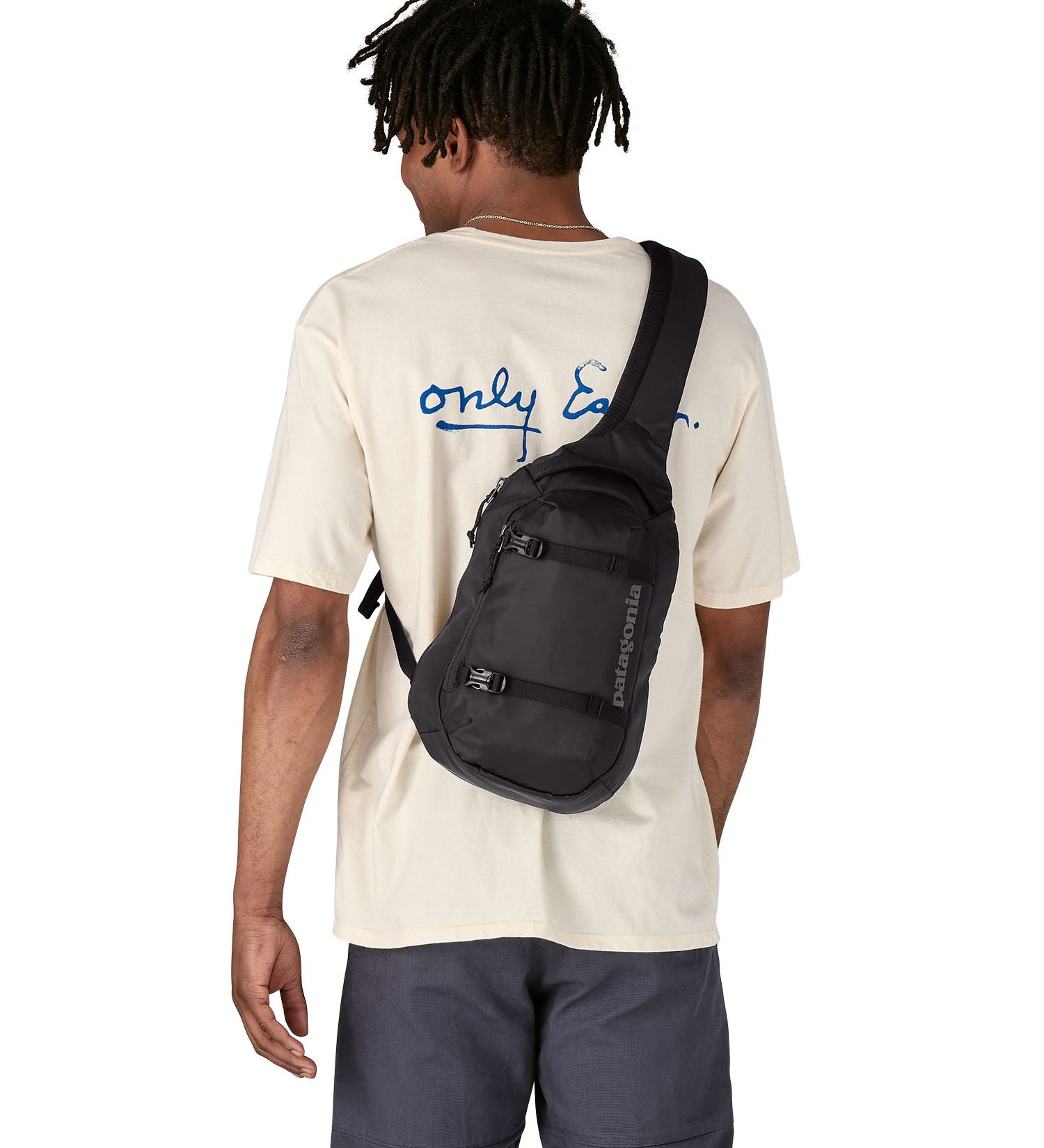 Patagonia 8L atom sling bag in a black colour worn by an adult