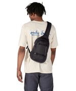 Patagonia 8L atom sling bag in a black colour worn by an adult