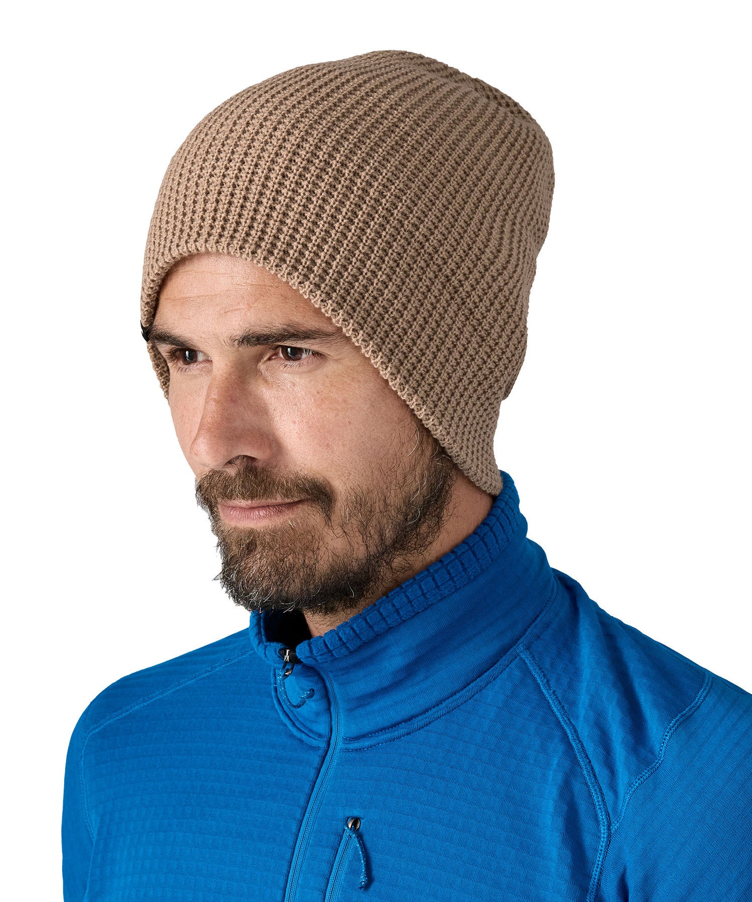 Patagonia adult snow drifter beanie in a pale khaki colour worn by a adult with the brim turned down to give a it a more fuller fit