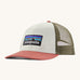 Patagonia adult birch white hat. A trucker style cap with a low profile in white colour and features a khaki mesh back with a coral brim and logo embroidery on the front panel