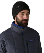 Man wearing the Patagonia brodeo wool blend unisex beanie in black.