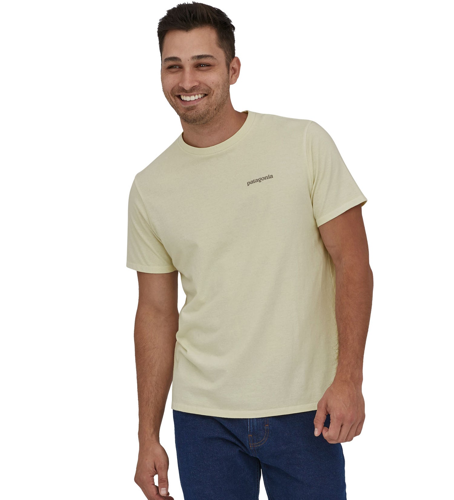 A man wearing a Patagonia Adult Fitz Roy Icon Responsibili-Tee in a Birch White colour stood in front of a plain background.