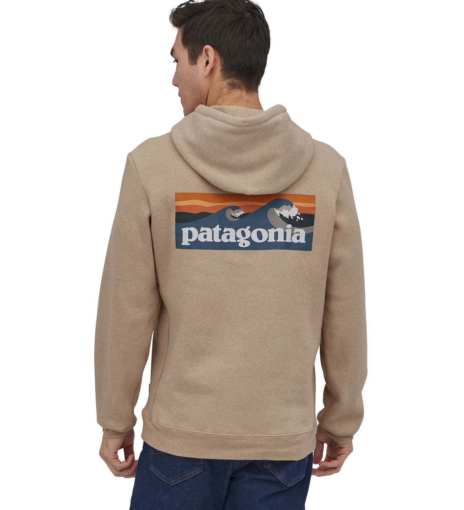 Man wearing Patagonia's men's boardshort logo uprisal hoody in light brown with large brand patch on upper back