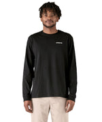 A adult wearing the black cotton Patagonia Adult  L/S P-6 Logo Responsibili-Tee. 