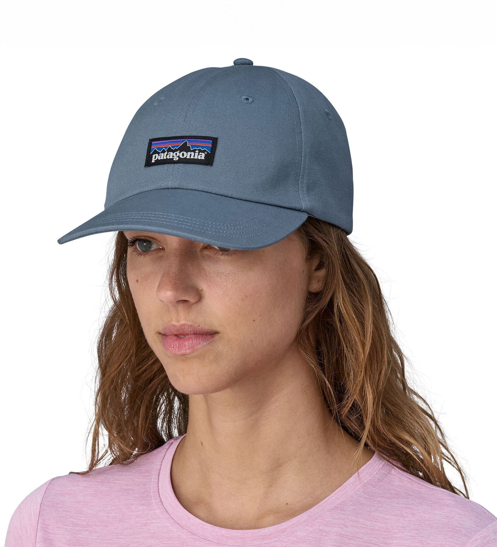 A woman wearing a Patagonia Adult P-6 Label Trad Cap in a mid utility blue colour.