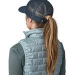 A woman wearing a Patagonia Adult P-6 Logo Trucker Hat in New Navy showing the back of the hat