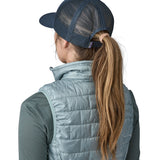 A woman wearing a Patagonia Adult P-6 Logo Trucker Hat in New Navy showing the back of the hat