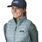 A woman wearing a Patagonia Adult P-6 Logo Trucker Hat in New Navy