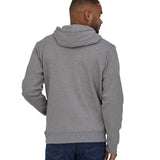 A man wearing a Patagonia Adult P-6 Logo Uprisal Hoody in a Gravel Heather grey colour stood in front of a plain background. He is facing away from the camera showing the back of the hoody. 