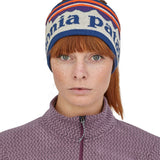 A close up of a woman wearing the Patagonia Adult Powder Town Headband Birch White