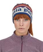 A close up of a woman wearing the Patagonia Adult Powder Town Headband Birch White