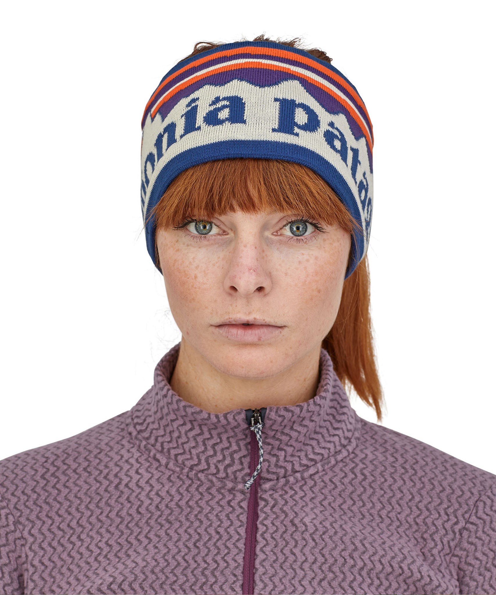 A close up of a woman wearing the Patagonia Adult Powder Town Headband Birch White