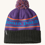 A black and purple adult Patagonia beanie hat with a orange strip and light blue branding on a cream background