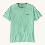 Patagonia adult short sleeve top in light green colour on a cream background.