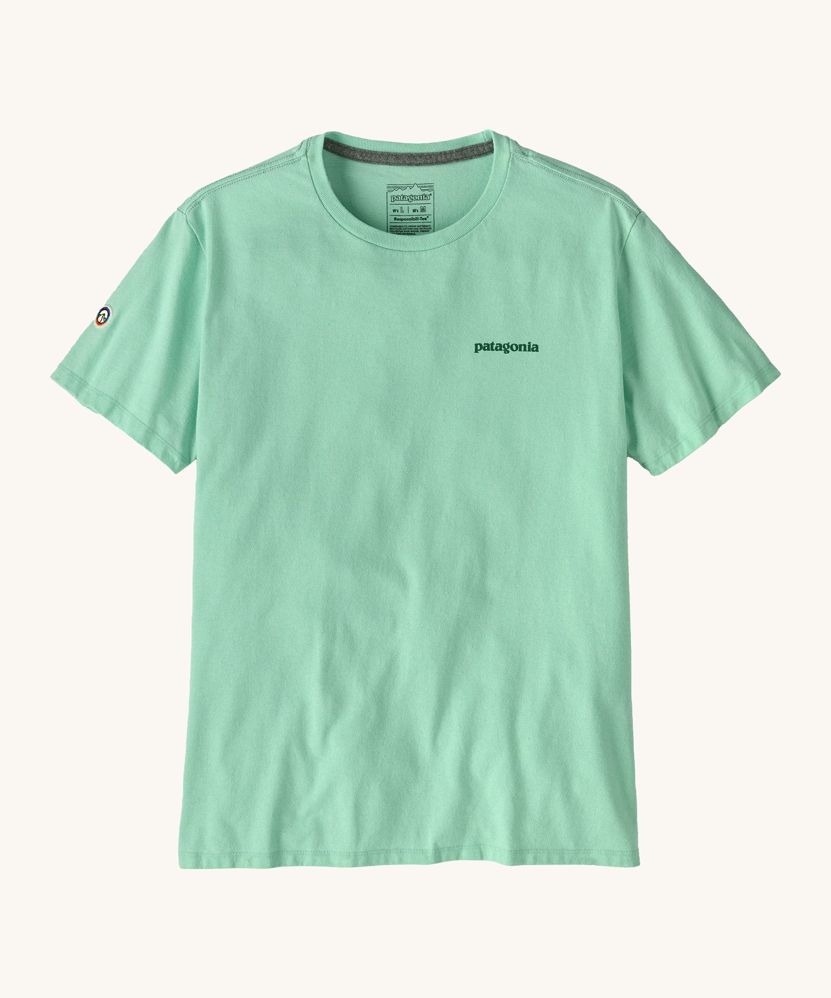 Patagonia adult short sleeve top in light green colour on a cream background.