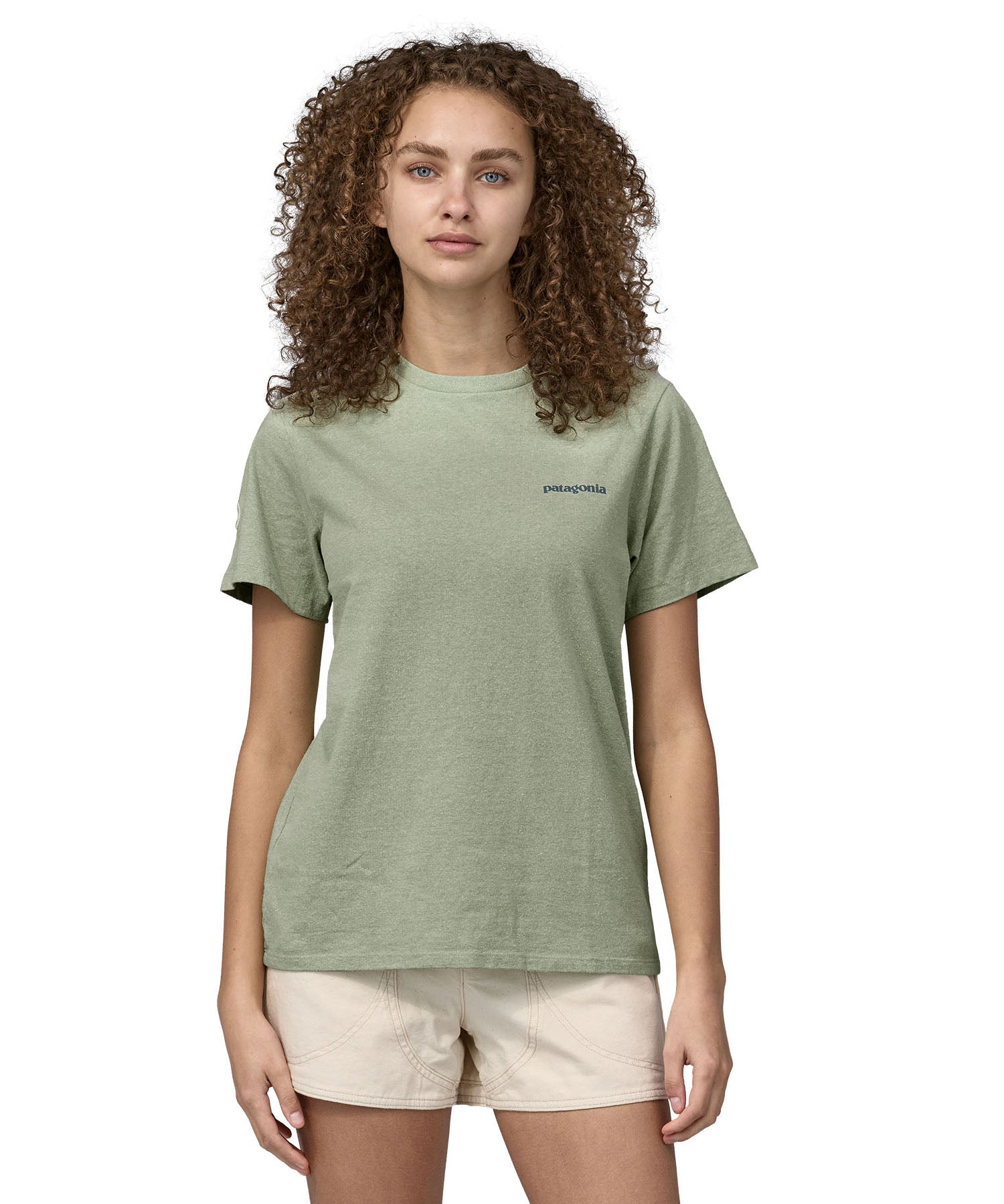 Patagonia adult short sleeve top in light green and logo text on the front worn by a woman