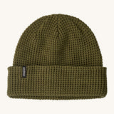 Patagonia adult snowdrifter beanie in tent green with rolled up brim. Features a brand logo patch stitched on the side