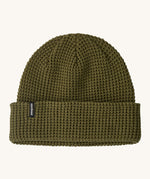 Patagonia adult snowdrifter beanie in tent green with rolled up brim. Features a brand logo patch stitched on the side