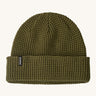 Patagonia adult snowdrifter beanie in tent green with rolled up brim. Features a brand logo patch stitched on the side