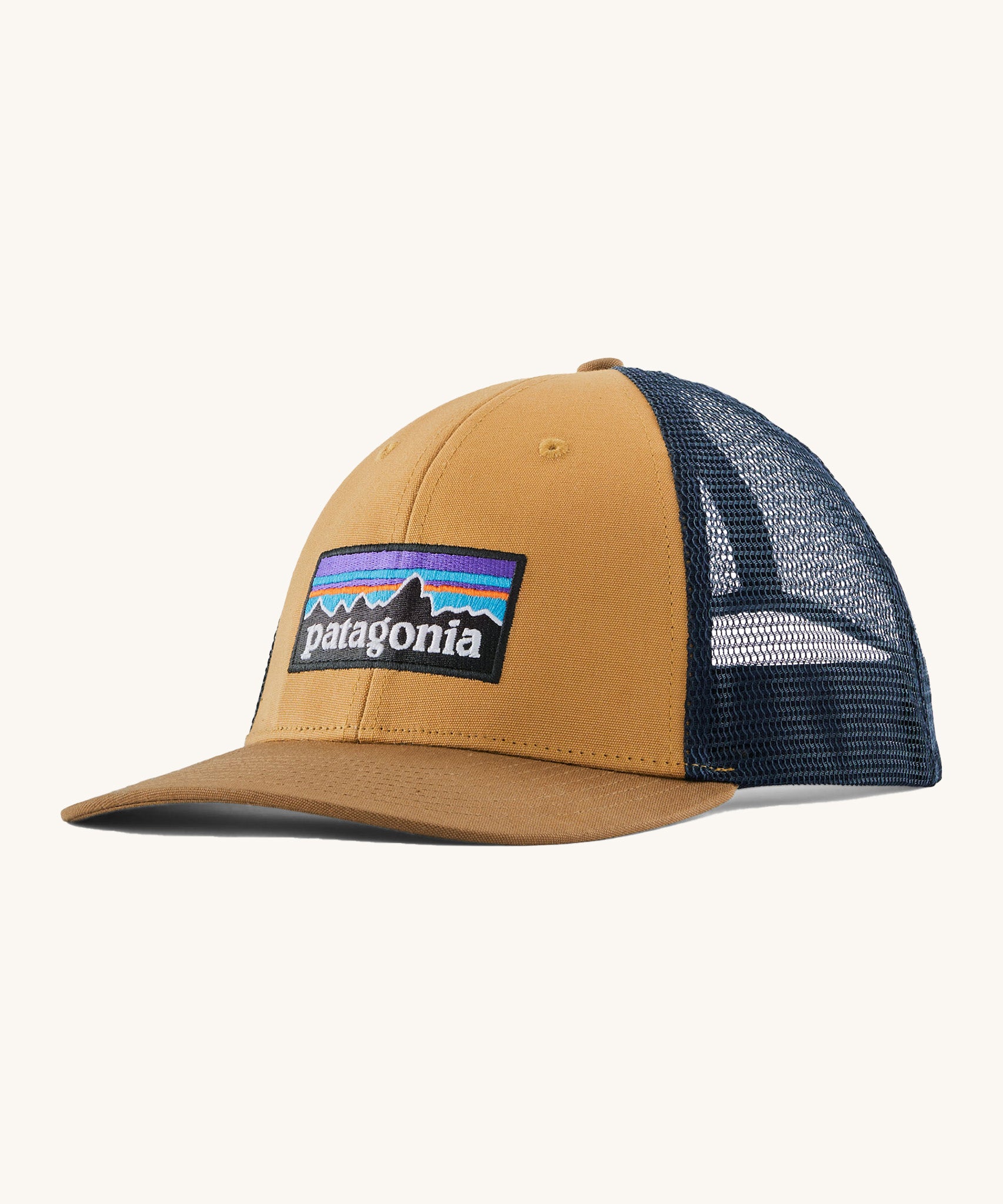 Patagonia adult talon gold hat. A trucker style cap with a low profile in gold colour and features a navy mesh back with a logo embroidery on the front panel