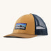 Patagonia adult talon gold hat. A trucker style cap with a low profile in gold colour and features a navy mesh back with a logo embroidery on the front panel