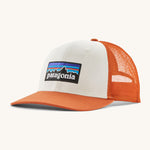Patagonia adult trucker hat in white and orange colour on a cream background.