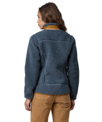 A woman wearing a Patagonia Women's Classic Retro-X jacket in a Utility Blue colour. The woman is facing away from the camera showing the back of the jacket. 