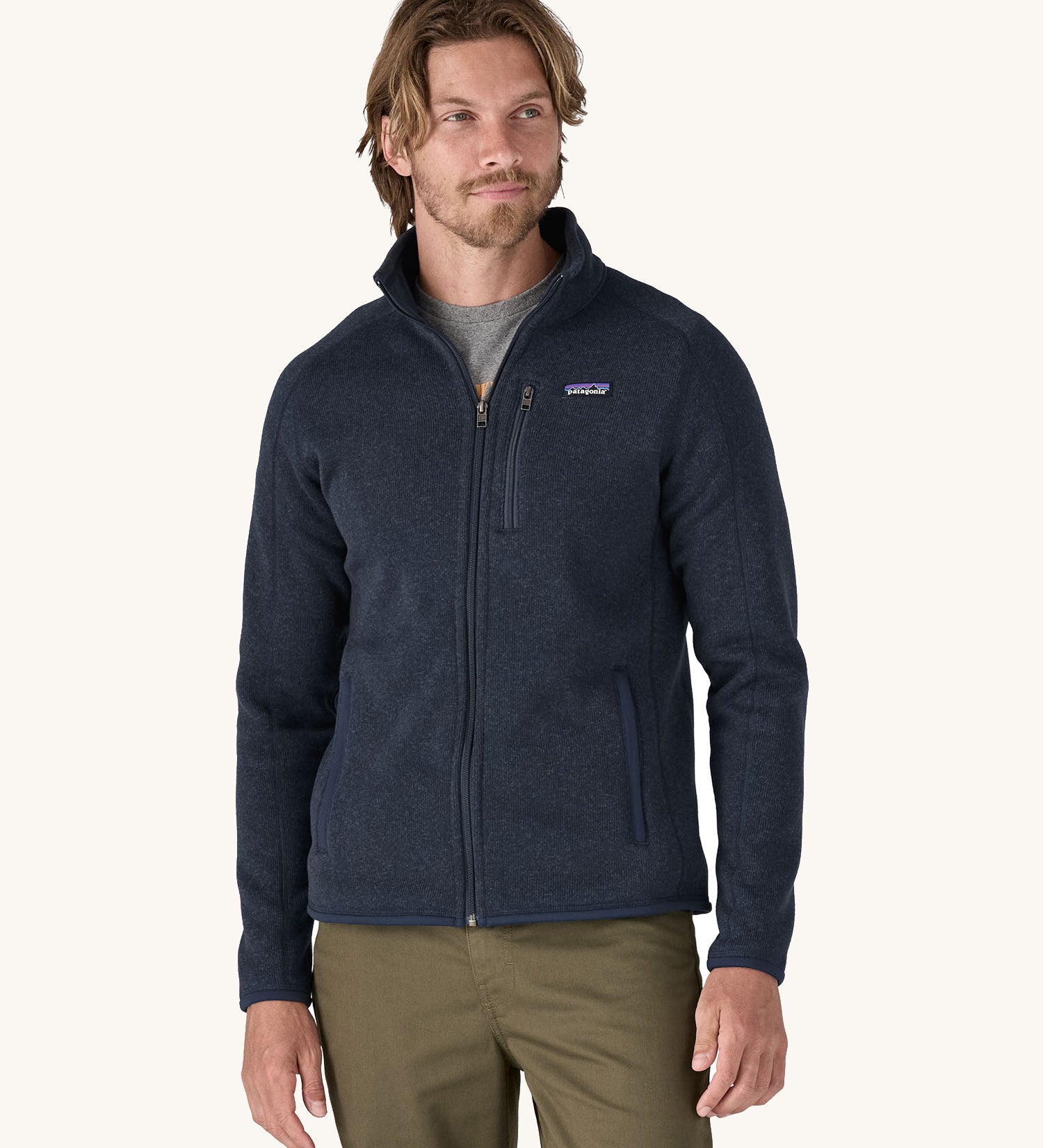 A man wearing the Patagonia Men's Better Sweater Jacket in a New Navy colour.