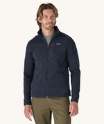 A man wearing the Patagonia Men's Better Sweater Jacket in a New Navy colour.