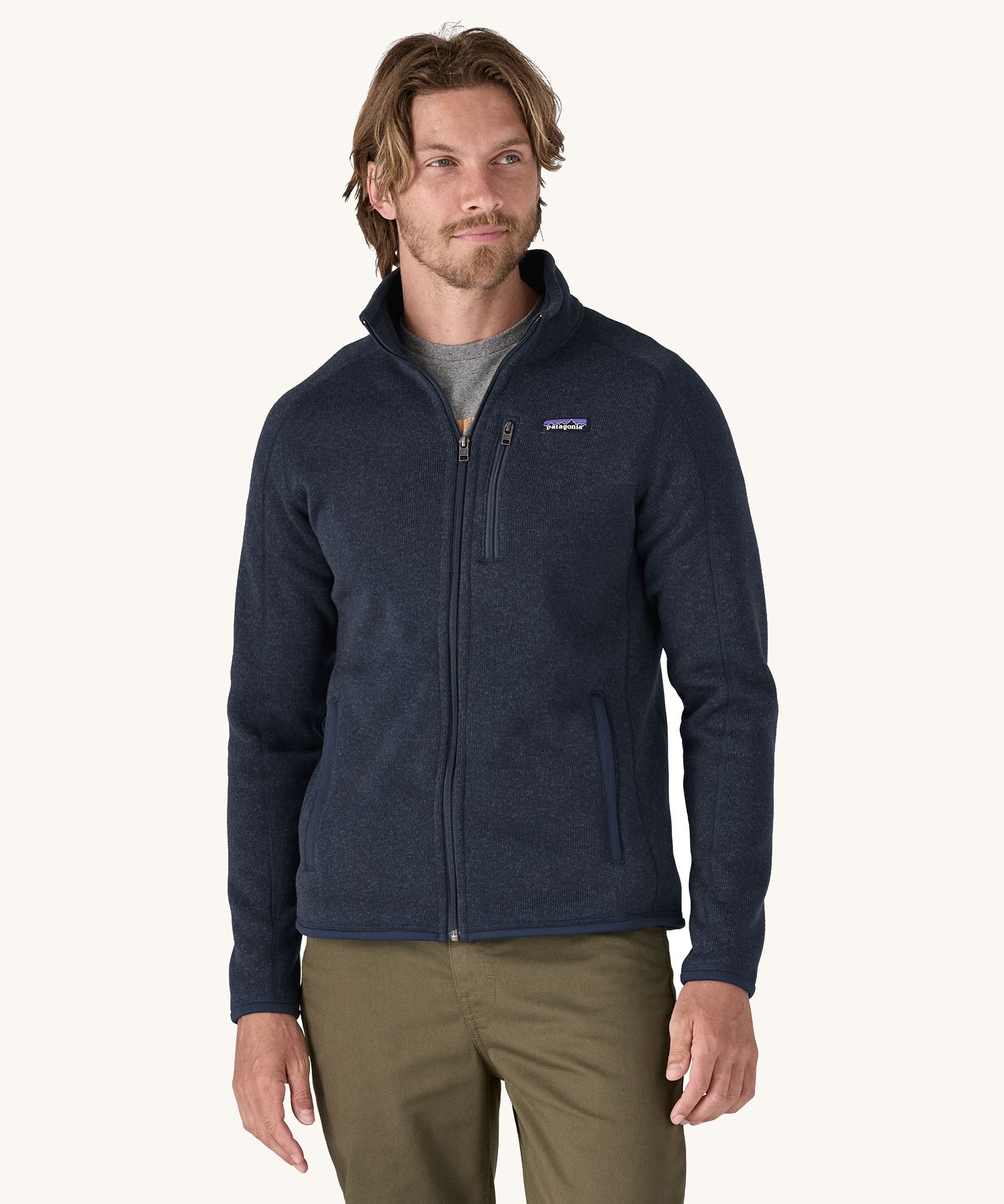A man wearing the Patagonia Men's Better Sweater Jacket in a New Navy colour.