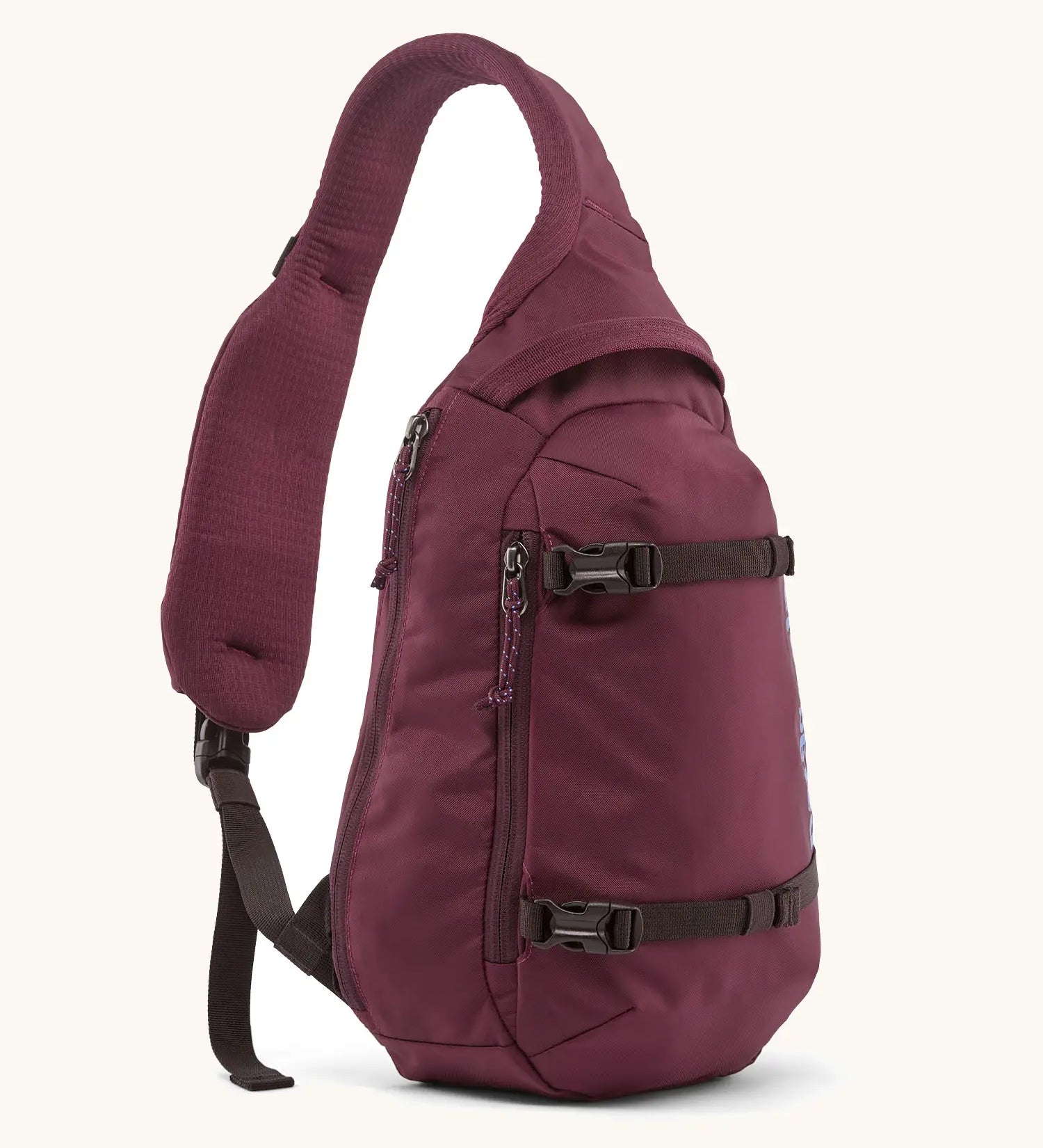 Patagonia atom sling 8L bag in berry fig. Over the shoulder strap with zipped compartments and equipment straps on the front.
